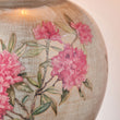 Decorative item with pink floral Rhododendrons  on a textured surface table lamp base
