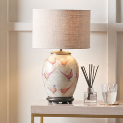 Decorative table lamp with a floral design on a marble surface. Jenny Worrall JW70 pheasant lamp.
